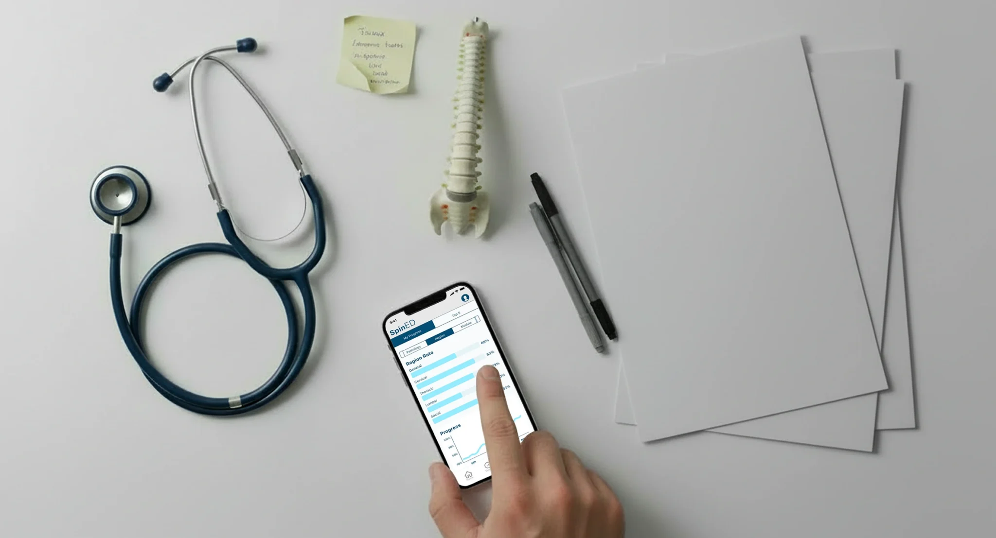 User interacting with a mobile app displaying medical learning content alongside clinical tools like a stethoscope and spine model