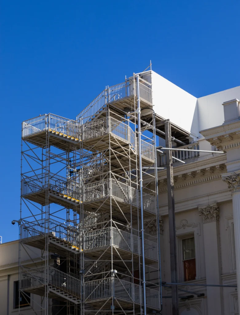 Scaffolding around a building being renovated, illustrating the choice to fix vs rebuild
