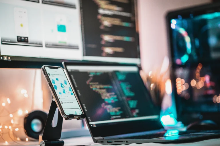 Multiple screens showing app code and a phone mockup, representing the testing and review work behind a production ready app