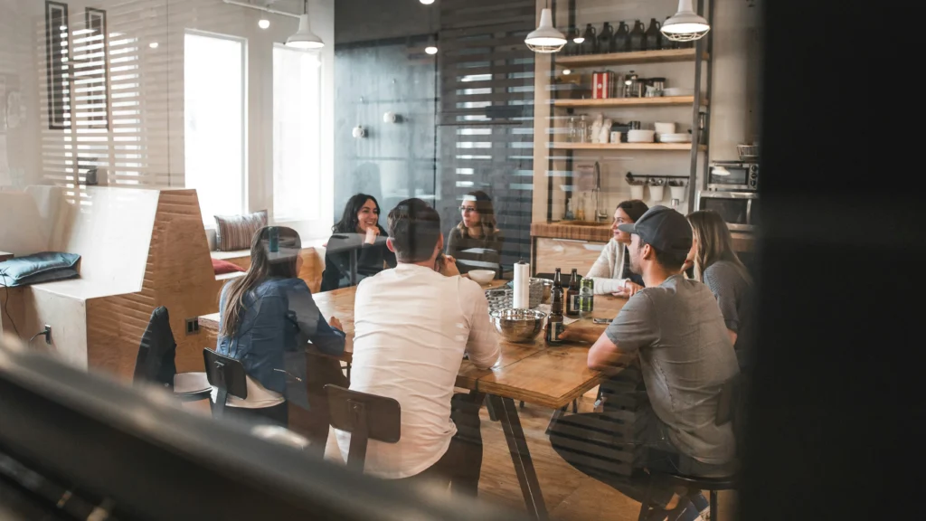 Team of developers collaborating around a table, discussing enterprise app development on Microsoft Azure
