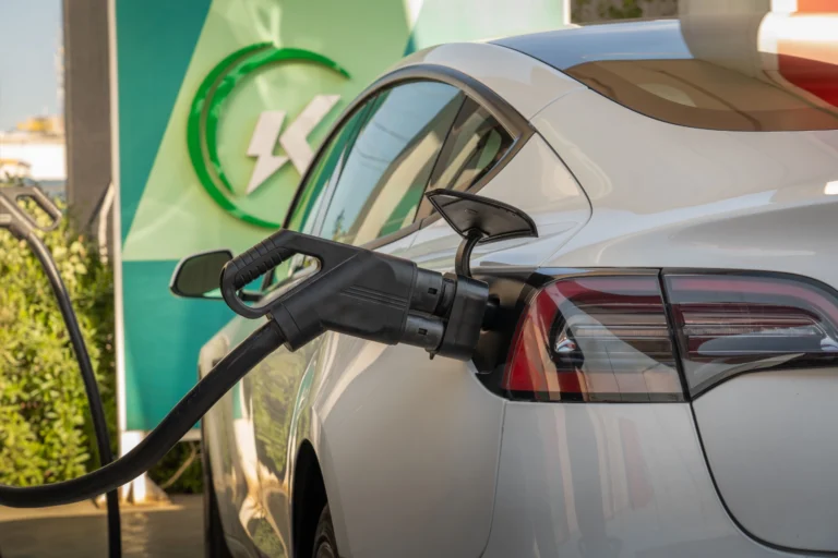 Electric vehicle plugged into a public charging station